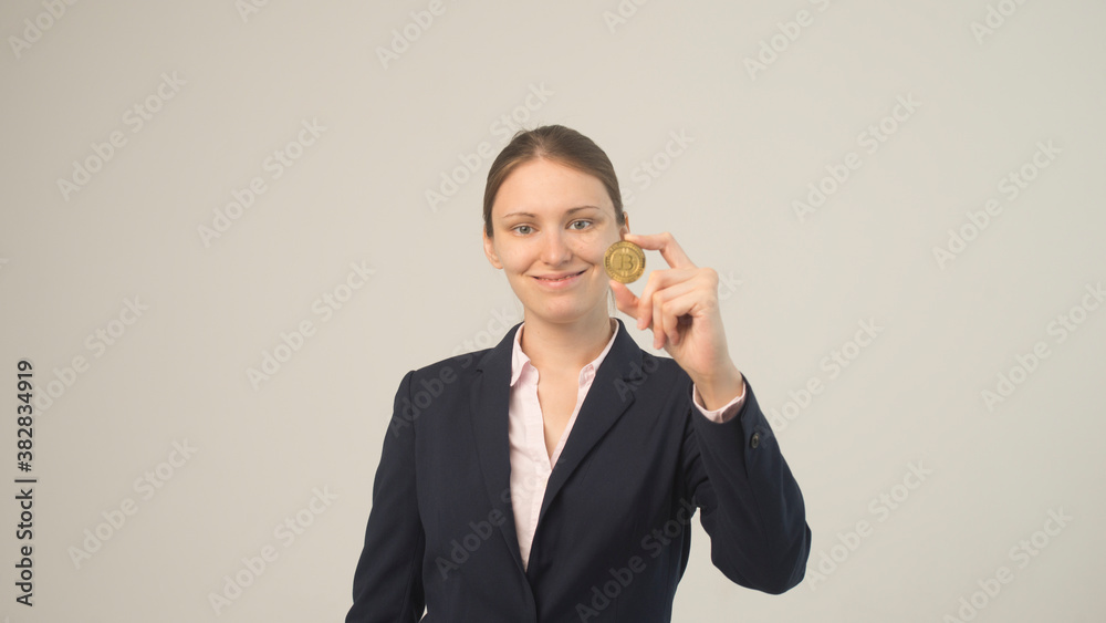 Woman holding a physical bitcoin cryptocurrency in her hand Woman holding a physical bitcoin cryptocurrency in her hand