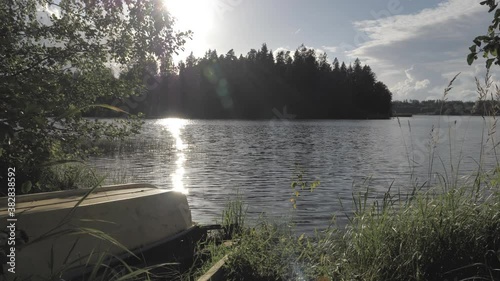 The sun setting on the sky in the lake Kokkoranta Finland photo