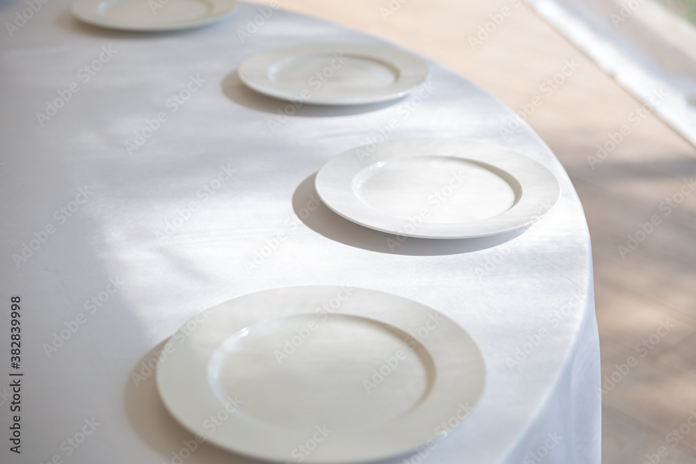 Table setting element empty plates with cutlery on white tablecloth. Table setting element empty plates with cutlery on white tablecloth.