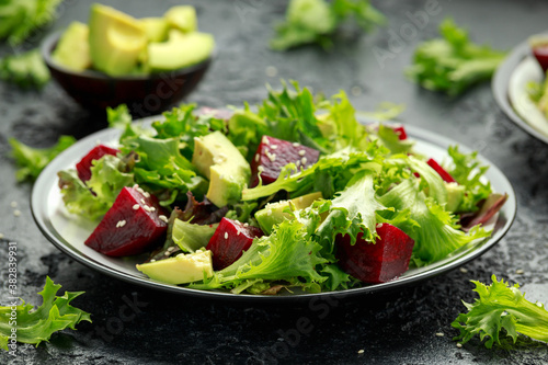 Vegetarian avocado and beet salad in plate. Healthy vegan food