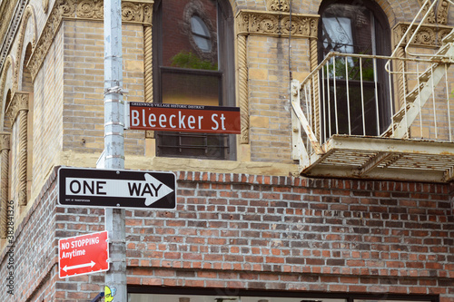 Street sign for Bleecker Street on the corner with Grove Street in New York City photo