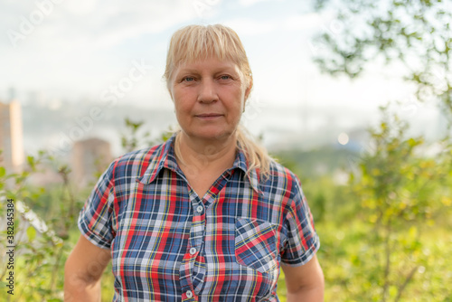 Portrait of a beautiful middle-aged woman outdoors. Selective focus.