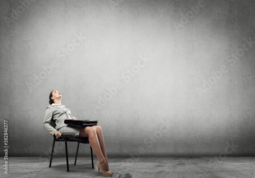 Emotional businesswoman in chair