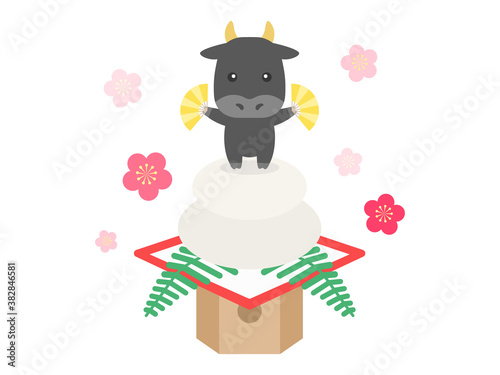 鏡餅にのった牛のキャラクターのイラスト