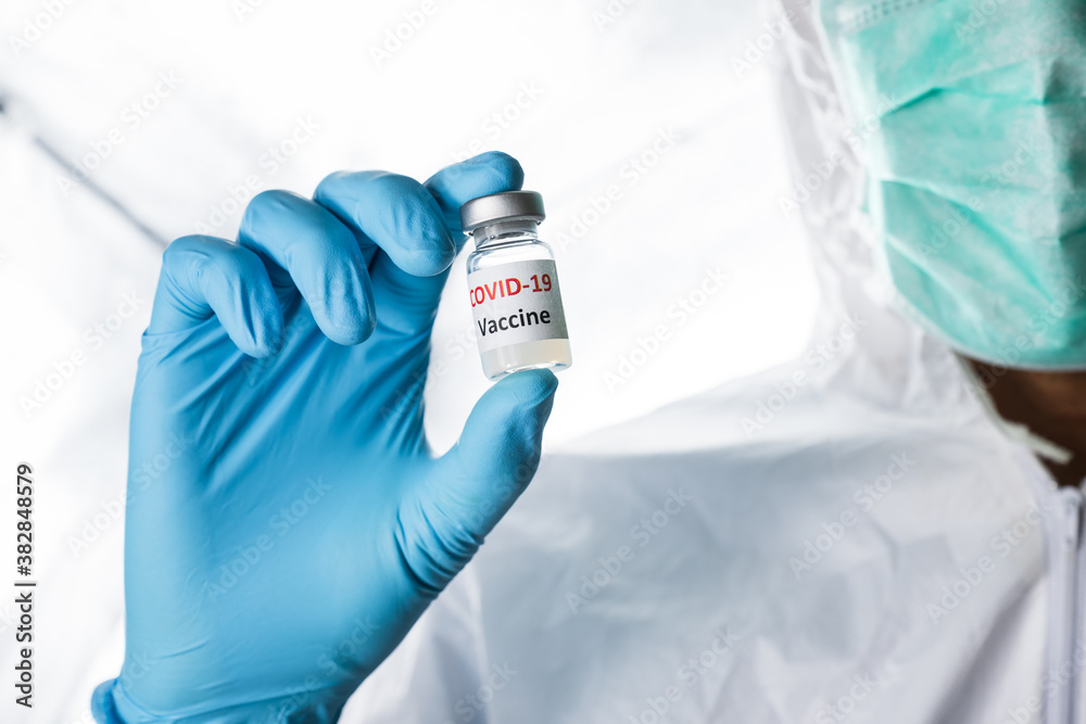 Doctor, nurse, scientist or researcher holding coronavirus (covid-19) vaccine for clinical trials in human Doctor, nurse, scientist or researcher holding coronavirus (covid-19) vaccine for clinical trials in human