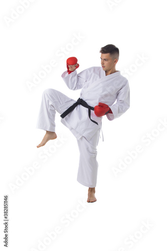 Man training taekwondo on white