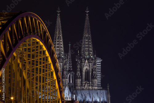 cologne cathedral at night with old bridge in the foreground