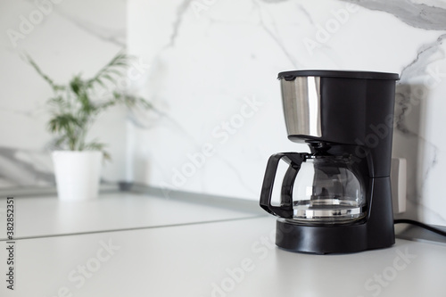 Konstfotografi Auto Drip Coffee Maker on white countertop at kitchen