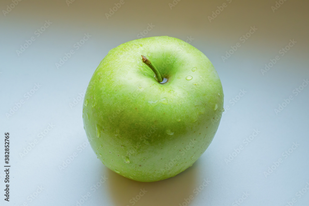 Green wet apple on white background. Green wet apple on white background.