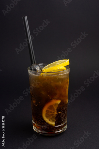 Long Island Ice Tea cocktail on black .background