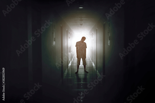 Bloody male zombie walking in the hotel corridor