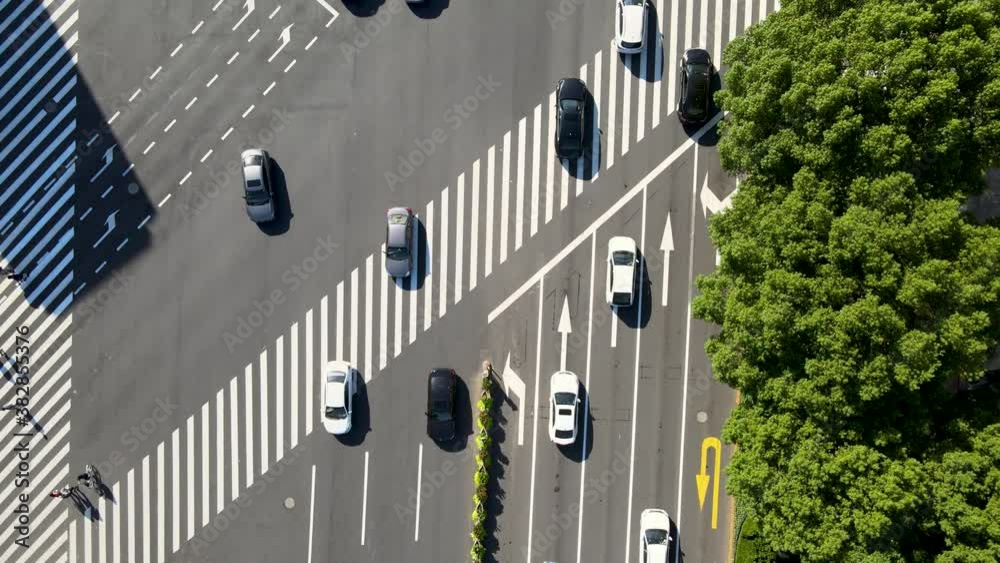 Drone aerial view of crossroad in modern city in rush hour pedestrians cars. Cozy calm city life concept footage. People walking on the zebra crossing traffic and vehicles around in Shanghai China Drone aerial view of crossroad in modern city in rush hour pedestrians cars. Cozy calm city life concept footage. People walking on the zebra crossing traffic and vehicles around in Shanghai China