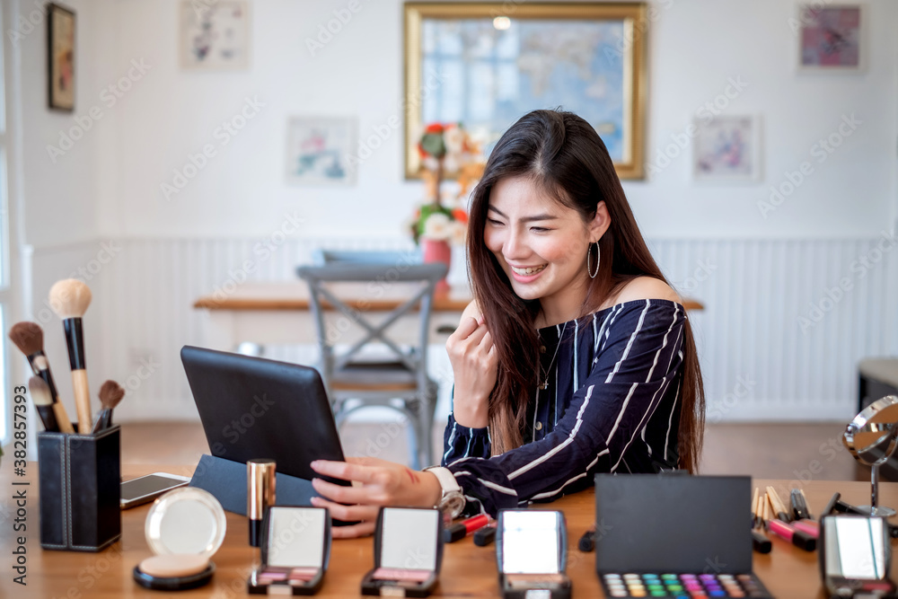 Young asian woman blogger recording video makeup cosmetic at home. Selling products online concept. Young asian woman blogger recording video makeup cosmetic at home. Selling products online concept.