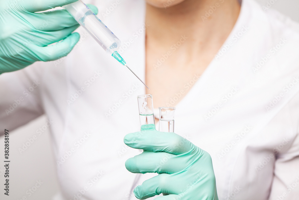 Hands of the doctors filling a syringe Hands of the doctors filling a syringe