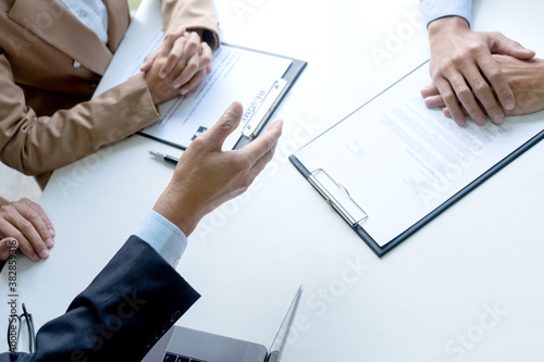 Businessmen are reaching a hand out for a handshake to congratulate