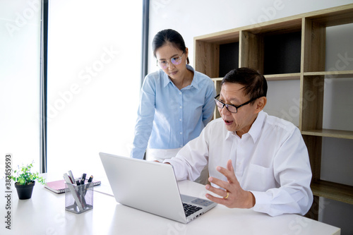 businessman sitting and woman standing talking discussing