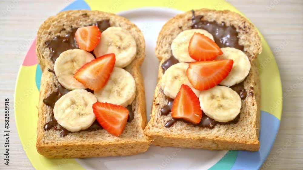 whole wheat bread toasted with fresh banana, strawberry and chocolate for breakfast whole wheat bread toasted with fresh banana, strawberry and chocolate for breakfast