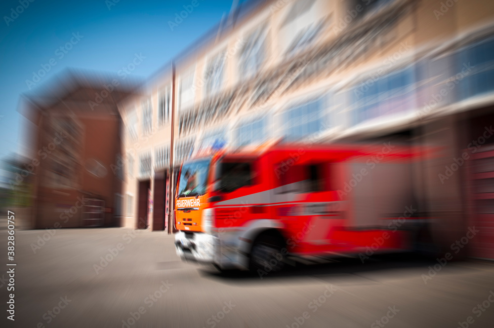 Fire truck leaving the station responding to an alarm Fire truck leaving the station responding to an alarm