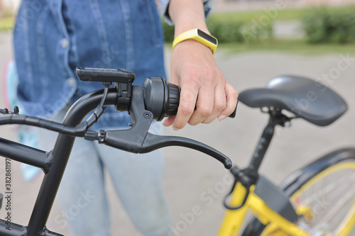 Healthy lifestyle. Woman hold handlebars of bicycle close up. Rent and hire of sports equipment.