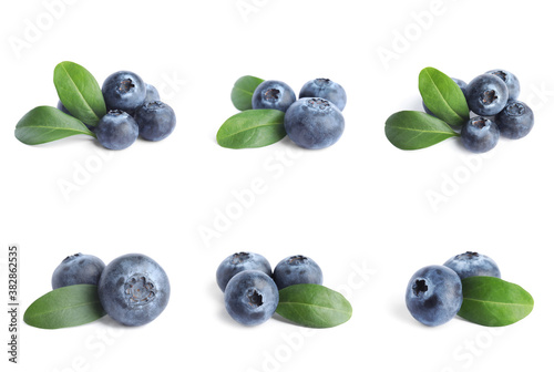 Set of fresh blueberries with green leaves on white background