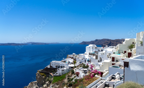 Panoramic view of Oia town in Santorini island with old whitewashed houses and traditional windmill, Greece Greek landscape on a sunny day