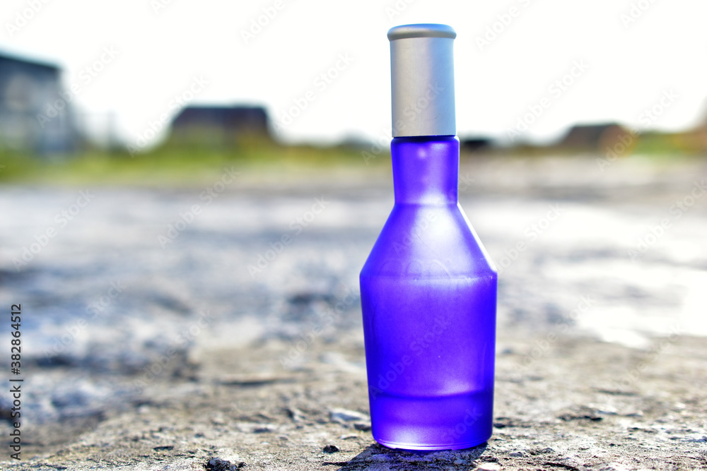Blue perfume bottle isolated on a white background