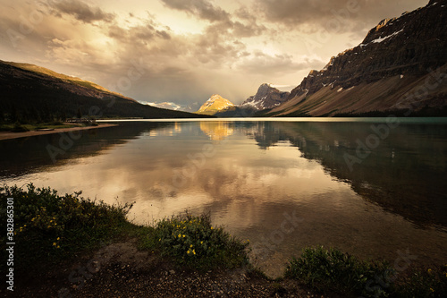 Cloud and storm reflections over Bow Lake in Alberta   Canada along the famous Icefield Parkway. Calm yet moody scene  tranquil isolation