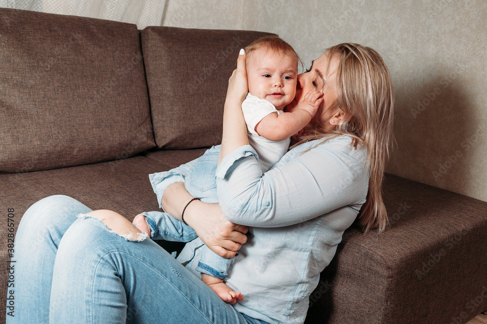 crying baby in the arms of my mother at home, mom soothes. crying baby in the arms of my mother at home, mom soothes.