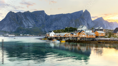 Bilde på lerret Traditional yellow rorbu house in drying flakes for stockfish cod fish in norwegian fjord in summer
