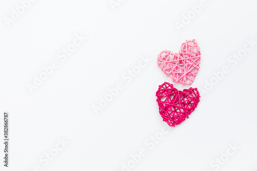 Two little wooden heart on white background, love and romance symbol, valentine concept background