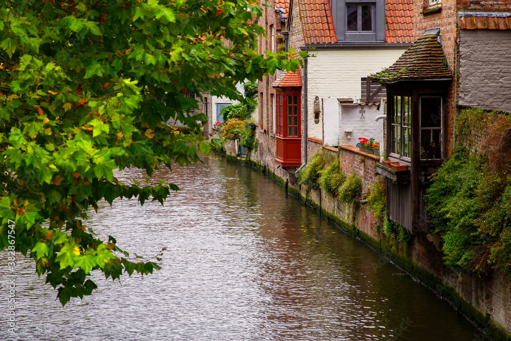 Bruges, Flanders, Belgium, Europe - October 1, 2019. Medieval ancient houses made of old bricks and water canals in Bruges (Brugge) West Flanders province, Belgium.
