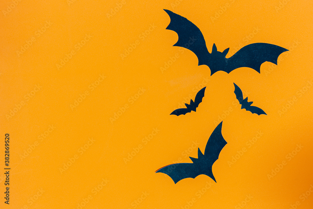 Halloween background ,bat with copy space on orange background Halloween background ,bat with copy space on orange background