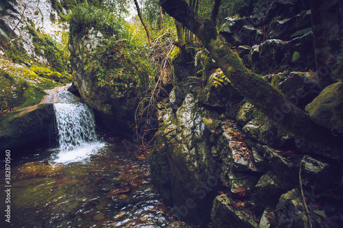 Waterfall in the middle of the forest surrounded by stones