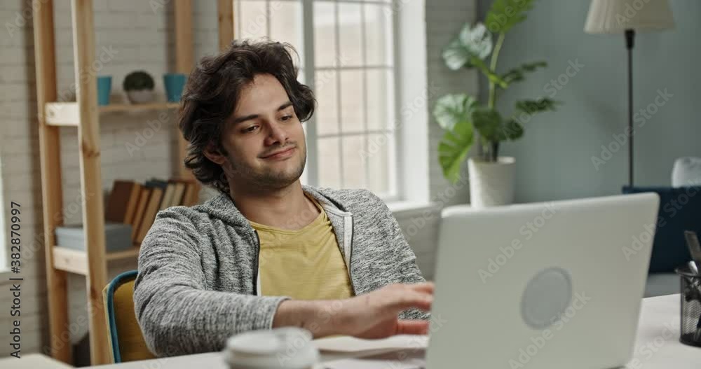 Young positive relaxed caucasian guy leaning back in his chair after finishing working on his laptop computer at home. Successful freelancer or remote worker on lockdown 4k footage Young positive relaxed caucasian guy leaning back in his chair after finishing working on his laptop computer at home. Successful freelancer or remote worker on lockdown 4k footage