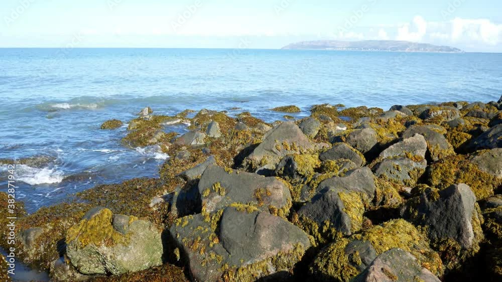 Clear blue ocean stone pebble beach coastline island holiday horizon scene Clear blue ocean stone pebble beach coastline island holiday horizon scene