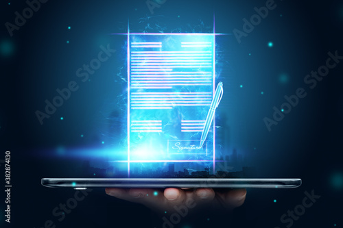 Male hand and modern smartphone hologram contract. Concept for electronic signature, business, remote collaboration, copy space. Mixed media. photo