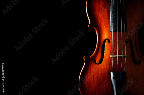 Violin on a black background. Ancient stringed instrument. Classical music.