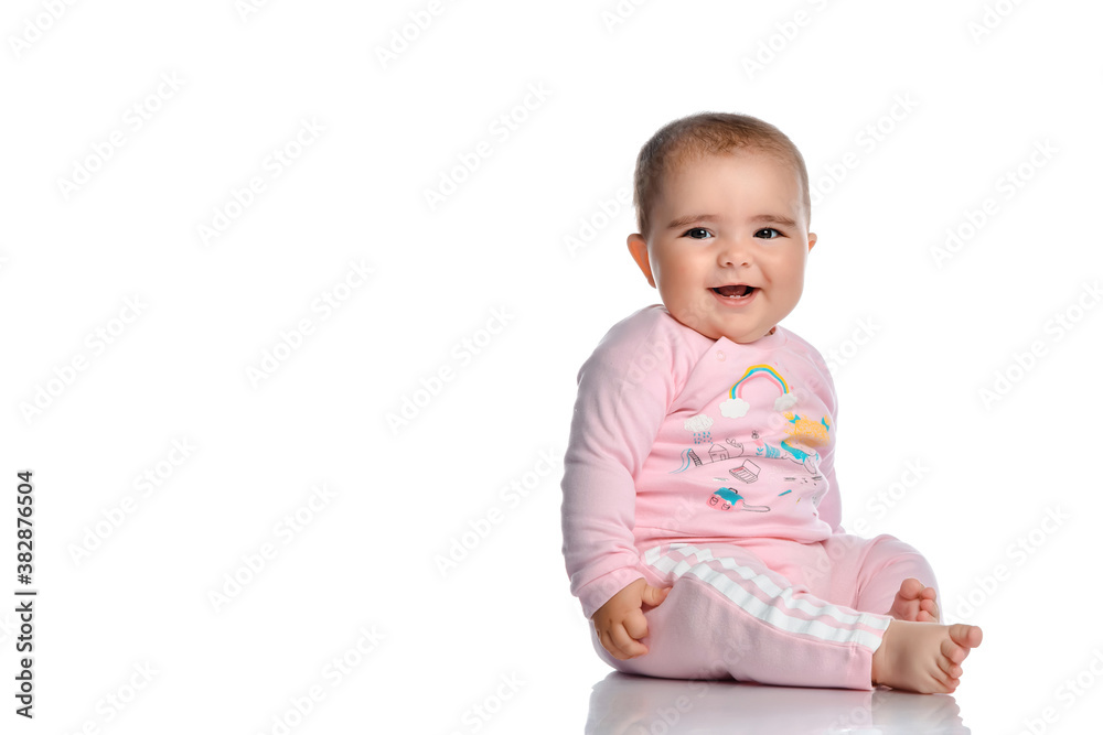 Cute little girl laughs looking at the camera on a white background. Cute little girl laughs looking at the camera on a white background.