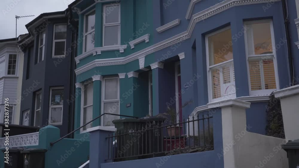 Beautiful close view of front houses painted in different colors in a street of brighton england uk during windy day Beautiful close view of front houses painted in different colors in a street of brighton england uk during windy day