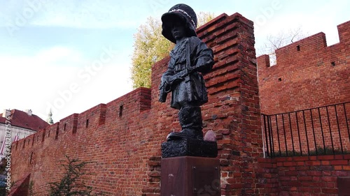 Closeup of the Little Insurgent war memorial in old town Warsaw, Poland. Motion shot.