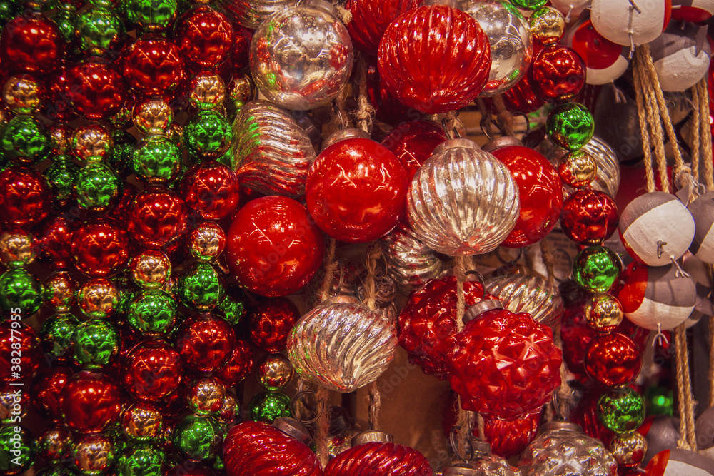 Christmas background of decorative balls including mercry ornaments in grreen and red and silver