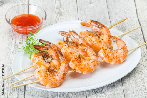 Grilled prawn skewer with sauce