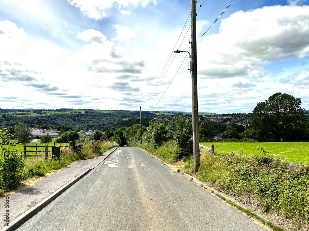 Park Lane, with fields, trees, and houses in the distance in, Halifax, Yorkshire, UK Park Lane, with fields, trees, and houses in the distance in, Halifax, Yorkshire, UK