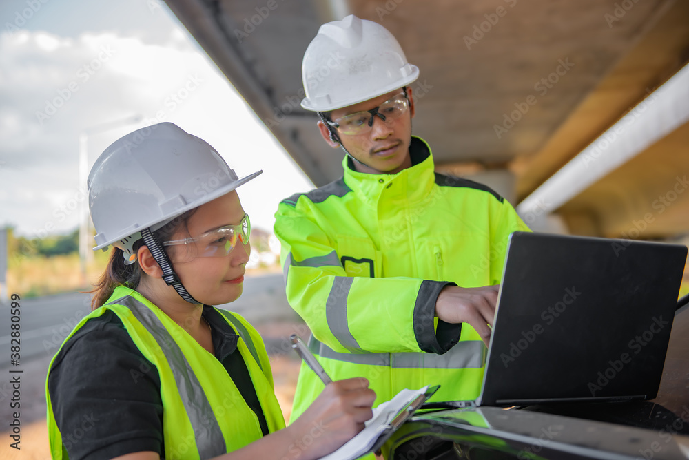 Two engineers discuss about work at the site of large bridge under construction,Management consulting people discussion with engineers about the progress and construction planning of highway Two engineers discuss about work at the site of large bridge under construction,Management consulting people discussion with engineers about the progress and construction planning of highway