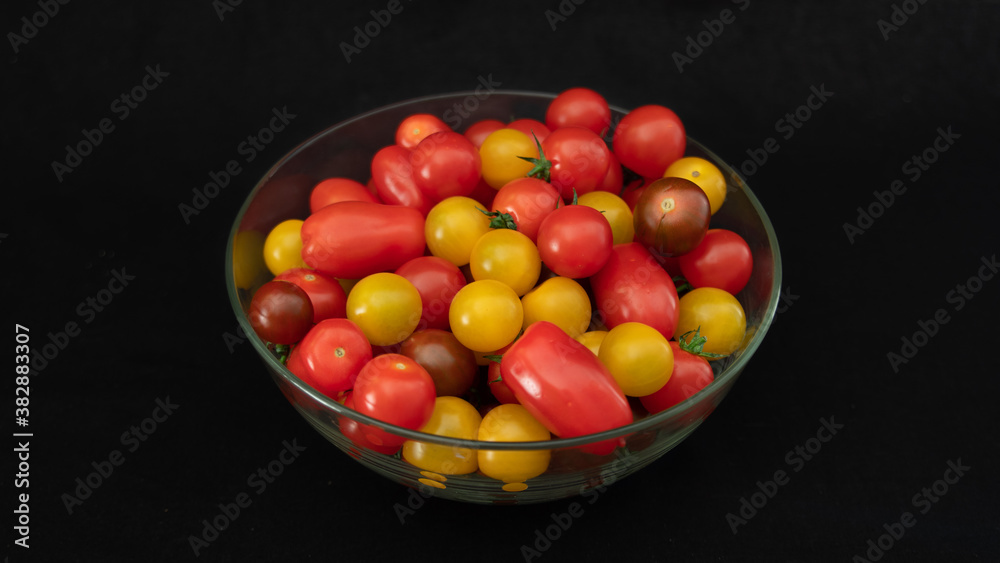 Small multicolored tomatoes in a glass bowl
Small multicolored tomatoes in a glass bowl