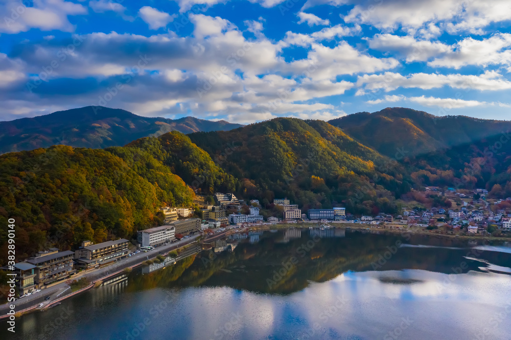 Japan. The Town Of Kawaguchiko. Houses on the shore of lake Kawaguchiko. A city between a lake and a mountain. Mountain landscape of Japan. Beautiful nature of Japan. Tourist attraction of Asia. Japan. The Town Of Kawaguchiko. Houses on the shore of lake Kawaguchiko. A city between a lake and a mountain. Mountain landscape of Japan. Beautiful nature of Japan. Tourist attraction of Asia.