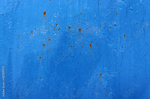 Blue cracked and scratched paint surface