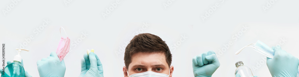 coronavirus concept banner, guy in mask, hands in gloves holds medical elements on white background