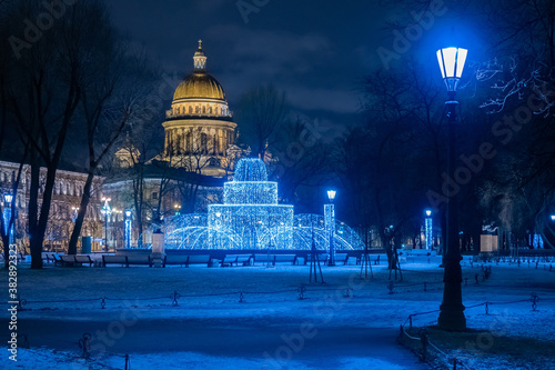Saint Petersburg. Russia. St. Isaac's Cathedral in the evening. Fountain of luminous garlands on the background of St. Isaac's Cathedral. Christmas decorations on the streets of the city.