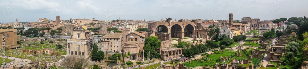 Ultra wide view of the ancient Roman Forum and the Colosseum in background in Rome